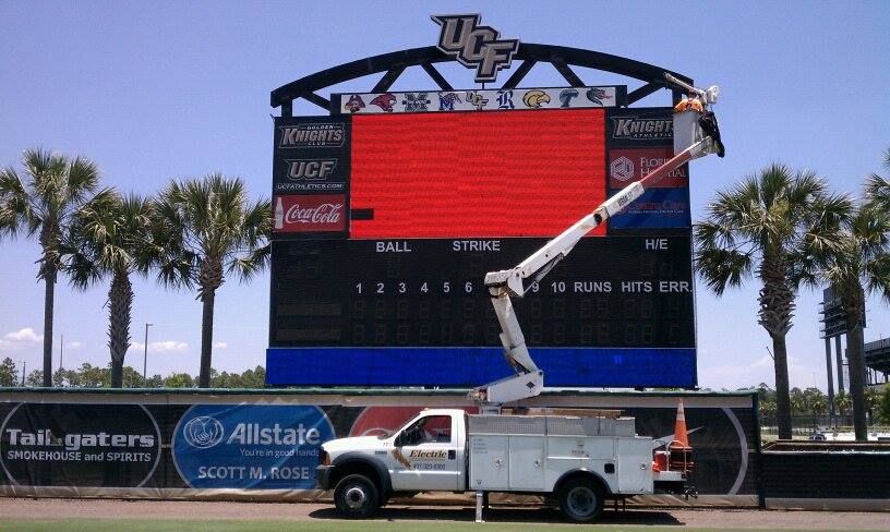 Using a Bucket Truck to Repair Digital Baseball Scoreboard Sign at UCF